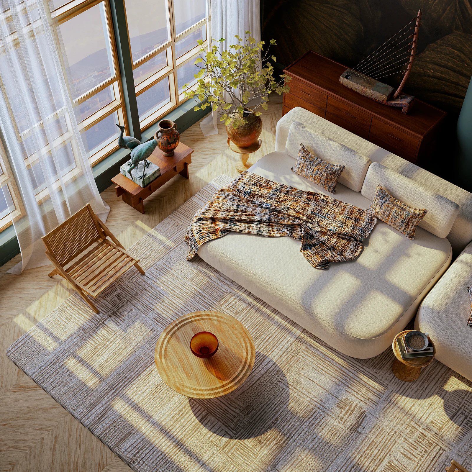 Bright modern living room with large windows casting shadows, featuring a beige sectional sofa with patterned pillows and throw, wooden chair, round wooden coffee tables, and decorative sculptures and plant by the window.